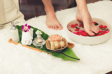 Man indulges in blissful foot massage at luxurious spa salon while masseur give reflexology therapy in gentle day light ambiance resort or hotel foot spa. Quiescent
