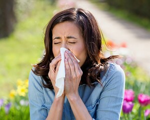 Woman Sneezing Outdoors in a Colorful Garden During Springtime