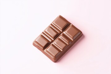 Fototapeta premium Single milk chocolate bar, rectangular shape, smooth surface, lies flat on a pastel pink background