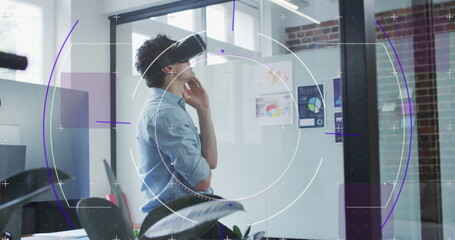 Image of purple light trails with hexagons over businessman wearing vr headset in office