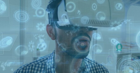 Image of scopes scanning on screens over man wearing vr headset