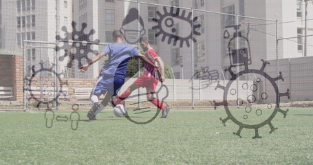 Image of covid 19 icons over two teams of male football players during game on pitch