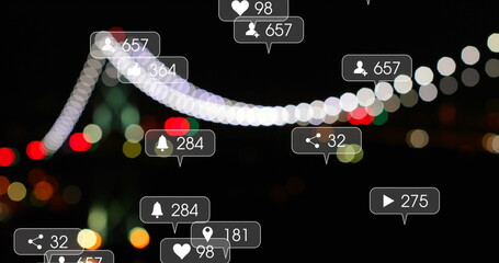 Image of social media icons and numbers on banners over flickering lights