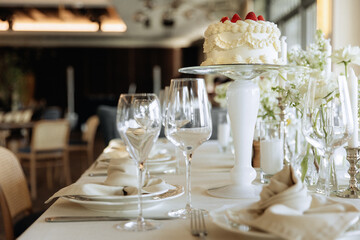 Elegant Table Setting with Cake and Wine Glasses