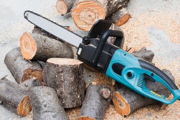 electric saw against the background of sawn logs close-up
