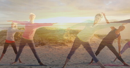 Image of glowing light over portrait of happy senior women exercising by seaside