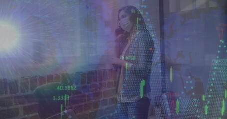 Image of data processing over woman talking on smartphone wearing face mask