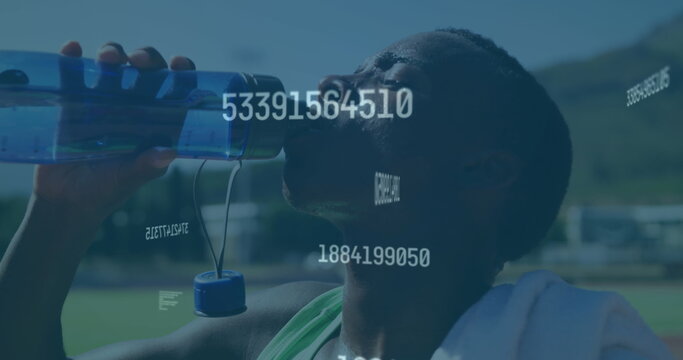 Image of digital data processing over male athlete drinking water