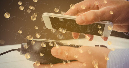 Image of bitcoins over smartphone and payment terminal