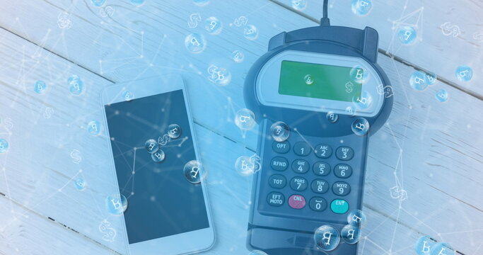 Image of bitcoins over smartphone and payment terminal - Powered by Adobe