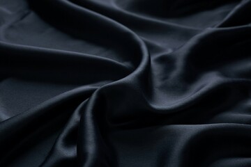Fototapeta premium Elegant Black Silk Fabric Texture Background With Subtle Waves And Folds