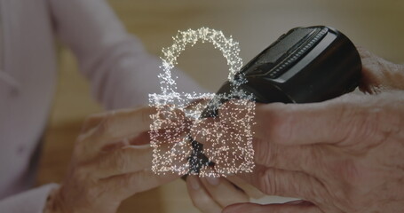 Image of network security padlock over people using payment terminal