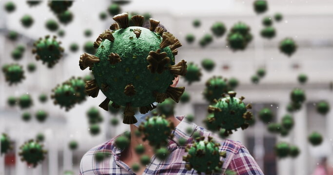 Image of covid 19 cells over caucasian man wearing face mask