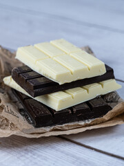 Close-up of stacked white and dark chocolate bars