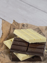 Close-up of stacked white and dark chocolate bars