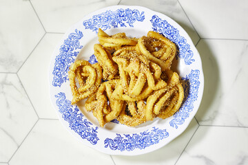 Griwech crunchy pastries , an Algerian dessert made with dough, fried and then coated with syrup and sesame seeds