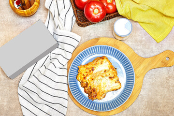 Freshly baked lasagna with meat and gruyere cheese  with mockup box