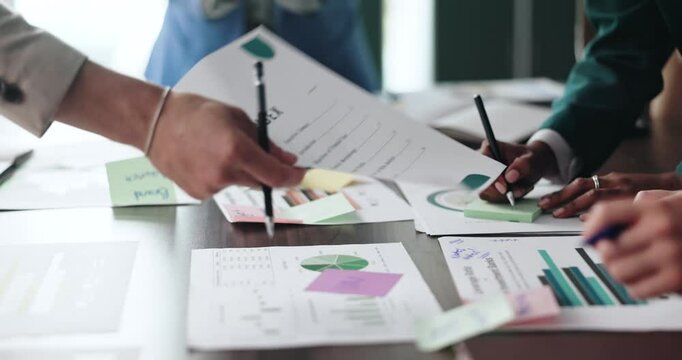 Meeting, hands and colleagues with documents, graphs and review of financial report and data analysis. Busy, business proposal and people with info for sales, chart and writing sticky notes in office