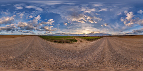 hdri 360 panorama on gravel road among farming fields with tire tracks with evening sky in equirectangular full seamless spherical projection, for VR AR virtual reality content
