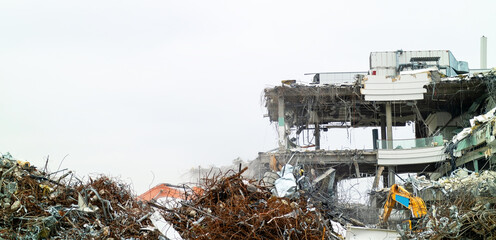 Demolition of a large building. Commercial real estate, to be destroyed by construction equipment....