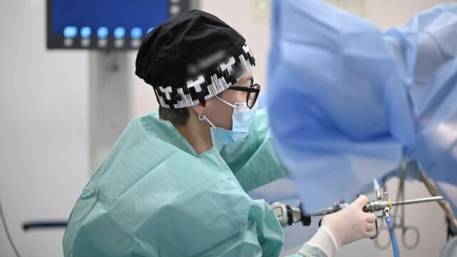 hysteroscopy operation. A cesarean operation is performed by a surgeon dressed in protective clothing