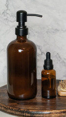  Amber glass shampoo and serum bottles with bamboo hairbrush on dark wood board and marble background. Minimalist flat lay showcasing natural, eco-friendly beauty and sustainable haircare.