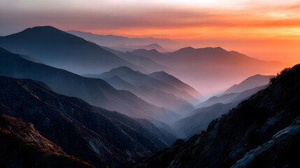 Hazy mountain skyline glowing in the fire of sunset light.