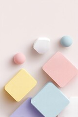 minimalist arrangement of pastel-colored geometric shapes on smooth white background