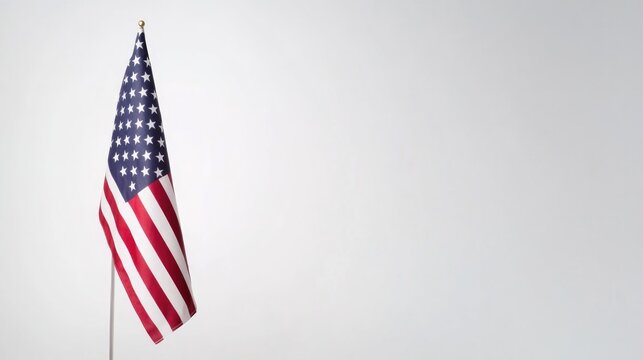 single american flag stands solemnly against pristine white backdrop with abundant copy space