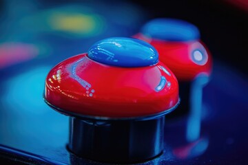 Close-up of vibrant red and blue buttons, possibly from an arcade game or vintage machine.