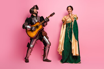 Medieval knight serenading an elegant princess with a guitar on a pink background, showcasing...