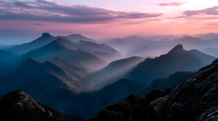 Fototapeta premium The last rays of the sun kiss the mountain peaks, turning them into golden silhouettes against the soft pink sky.