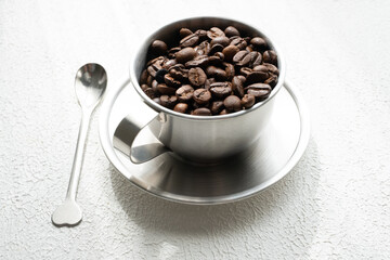 coffee beans in a metal cup close up