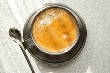 coffee beans, a cup of espresso and ground coffee on wooden background
