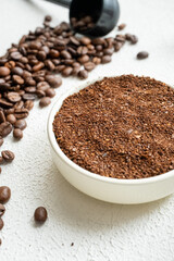 cup of coffee with beans white wooden background