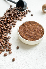 cup of coffee with beans white wooden background