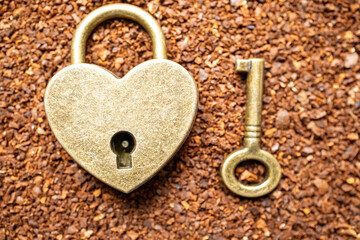 Heart shaped lock on coffee and coffee beans