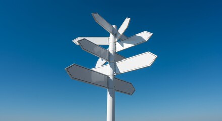 Blank Direction Signs Against Blue Sky - Decision making, choices, options, directions, and pathways symbolized by blank white directional signs against a vibrant blue sky