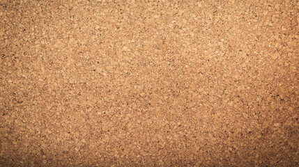 Fototapeta premium A textured cork board surface is displayed, featuring a warm beige hue. The granules vary in size and shape, giving a natural, organic appearance suitable for crafting and bulletin boards