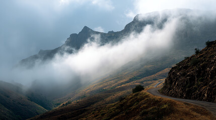 A mountain pass with fog rolling through