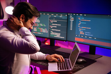 IT developer being tried of overwork on solve problem in error software coding system with sitting...
