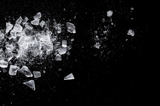 Ice shards crush on a black background. Chill backdrop.