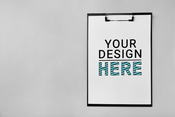 Clipboard with sheet of paper on grey background, top view. Mockup Your Design Here