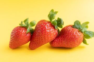 Strawberries are large and standing in a row