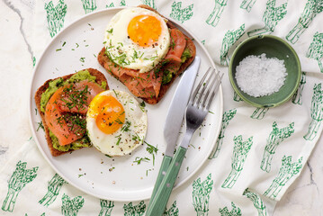Avocado, Smoked Salmon and Fried Egg Toast for Breakfast for breakfast  .Healthy appetizer.