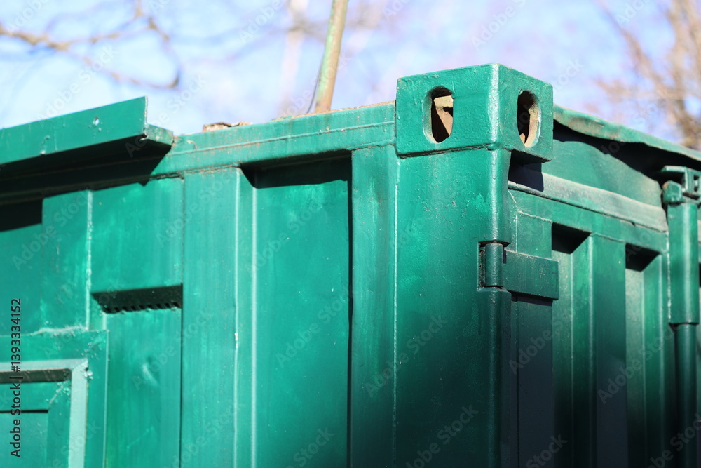 Poster A detailed view of a green trash can with a lid and a handle, suitable for use in illustrations about recycling or waste management.