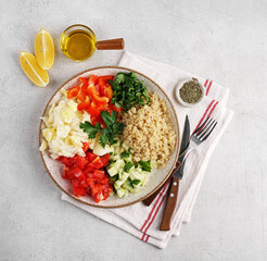 Healthy vegetarian salad with quinoa, tomatoes, green salad and pepper. Close up. Top view.