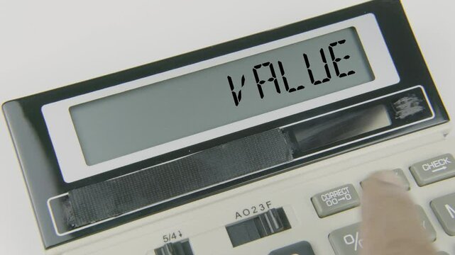"Value" text or words displayed on a calculator's LED screen as a hand types numbers, symbolizing the process of assessing, calculating, and determining the worth or value of assets, investments