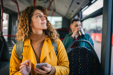young adult woman enjoy while use mobile phone and riding a bus