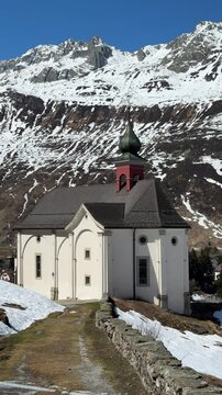 Mountain village of Andermatt in Switzerland, Alps and Swiss landscape, church of Chapel Maria Hilf